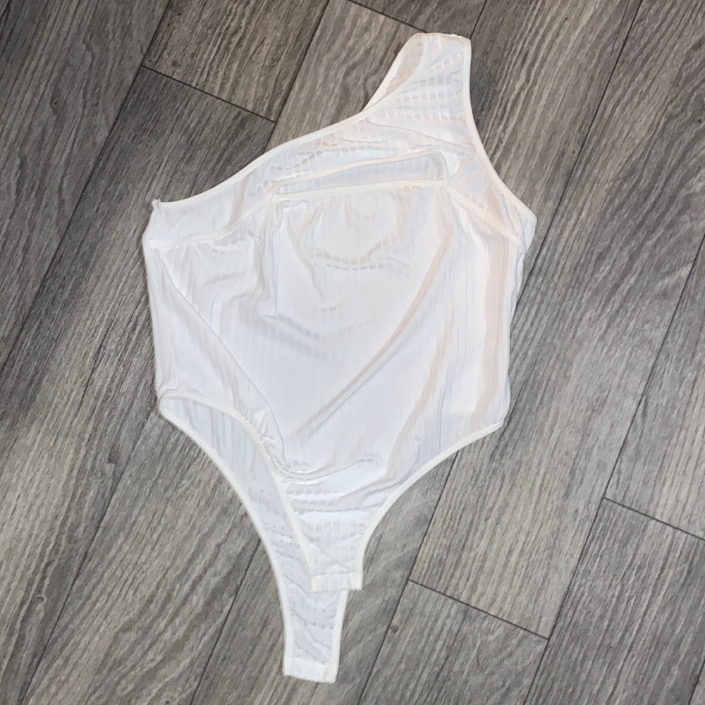 One shoulder body suit with chest cut out.